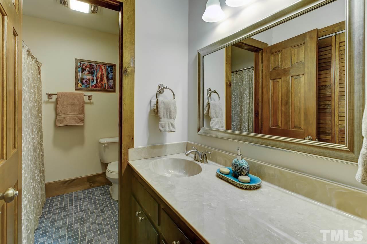 7850 James Austin Road Willow Spring, NC 27592 - Photo 18 of 25 a bathroom with a sink and a mirror