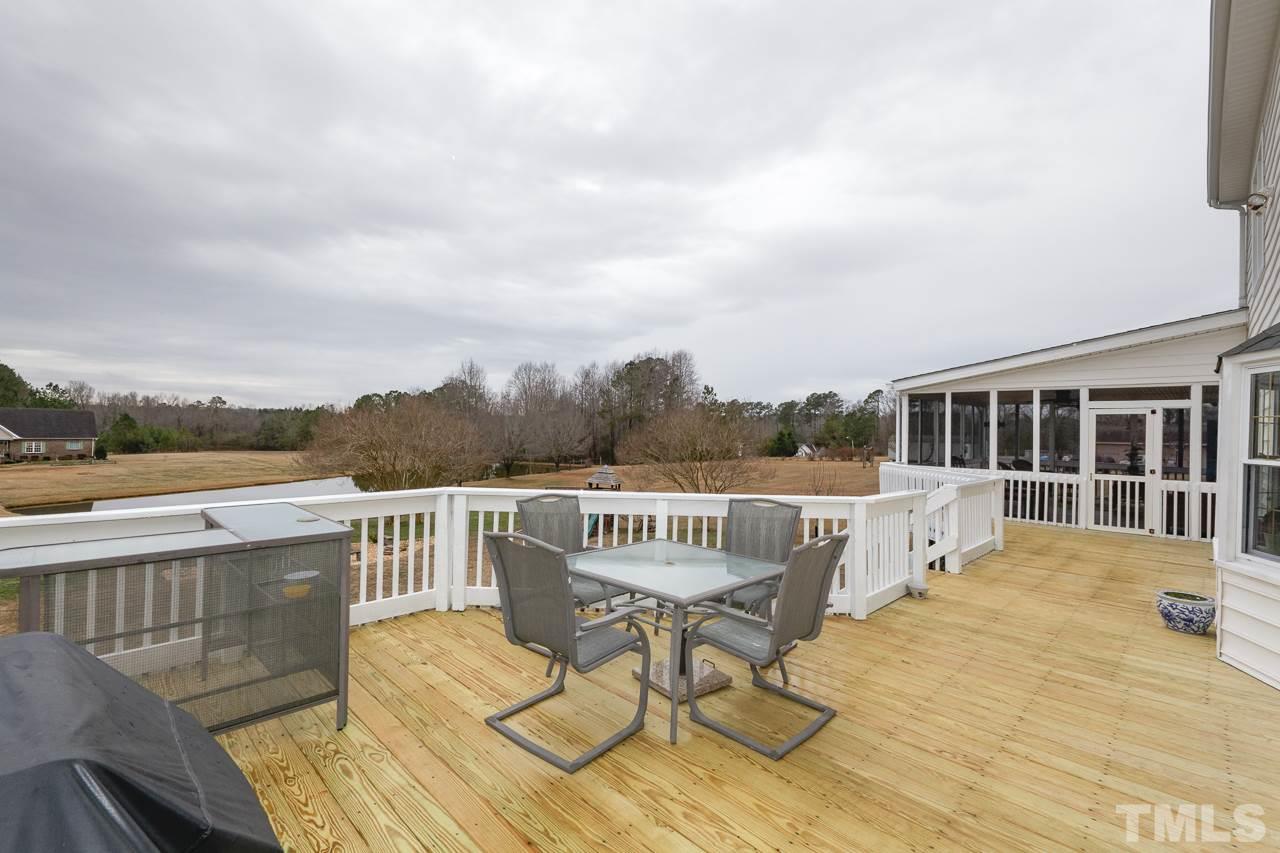 7850 James Austin Road Willow Spring, NC 27592 - Photo 21 of 25 a view of a chair and table on the terrace