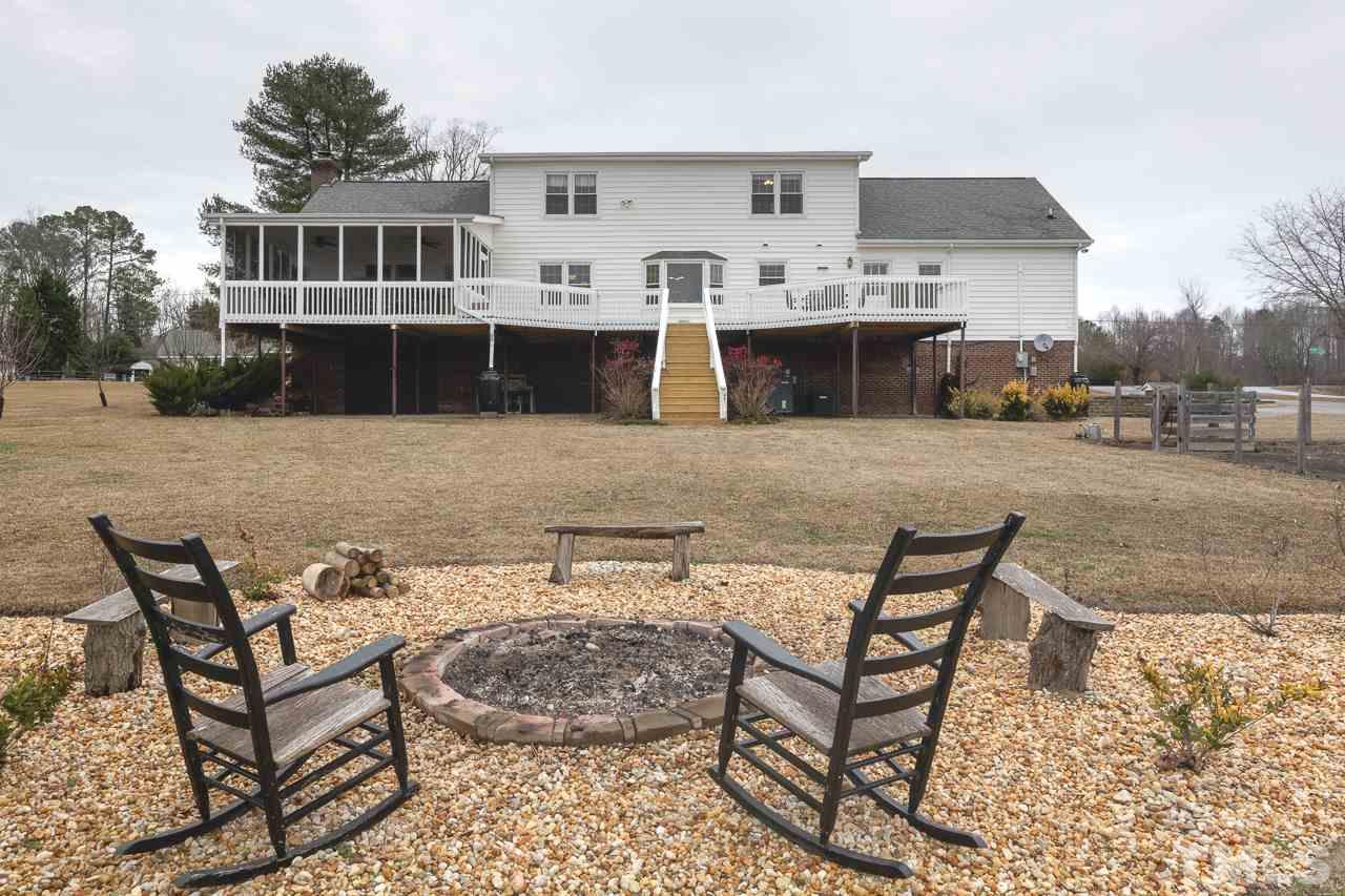 7850 James Austin Road Willow Spring, NC 27592 - Photo 22 of 25 a view of a house with backyard and sitting area