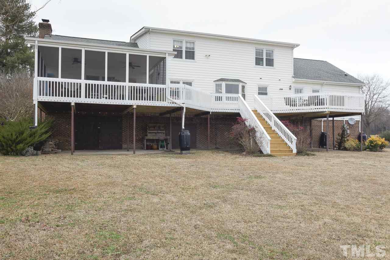 7850 James Austin Road Willow Spring, NC 27592 - Photo 24 of 25 a view of a house with a yard and garage