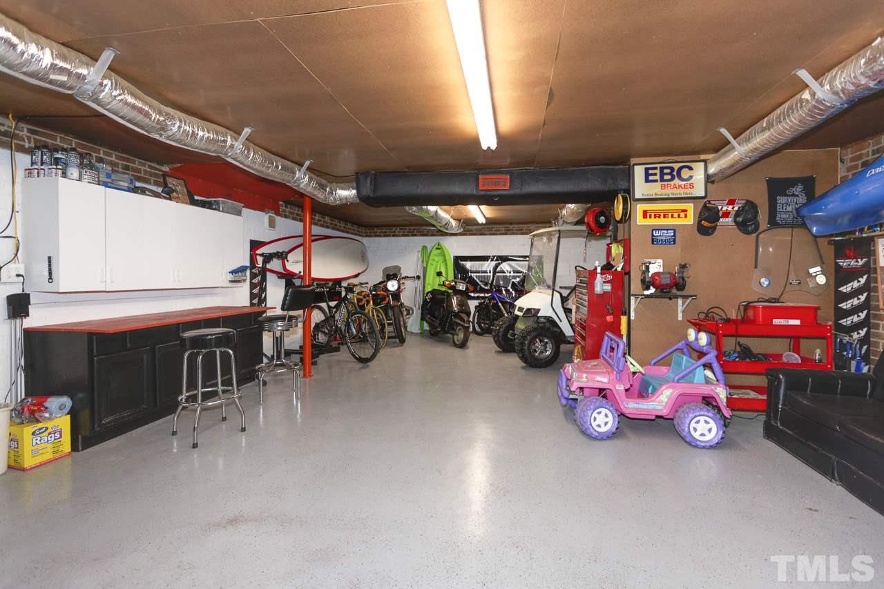 7850 James Austin Road Willow Spring, NC 27592 - Photo 25 of 25 a view of a garage with a bike and car