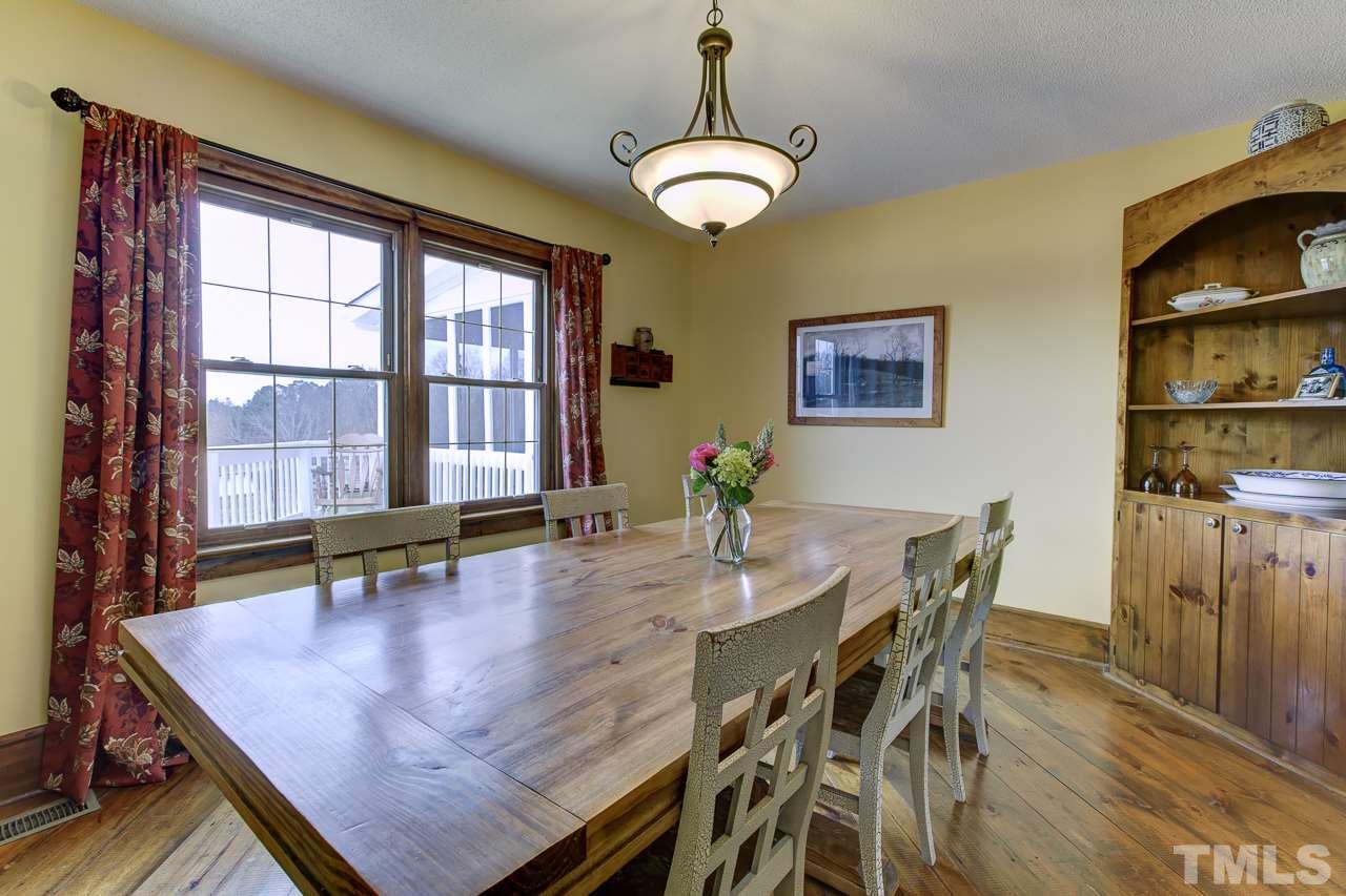 7850 James Austin Road Willow Spring, NC 27592 - Photo 5 of 25 a dining room with wooden floor and large window