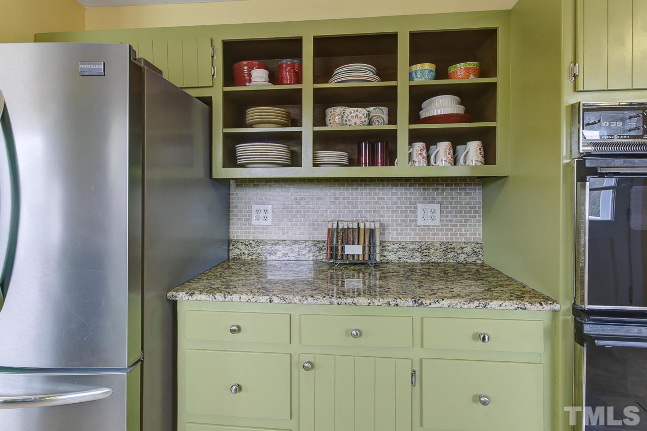 7850 James Austin Road Willow Spring, NC 27592 - Photo 9 of 25 a kitchen with stainless steel appliances granite countertop a refrigerator and a counter space
