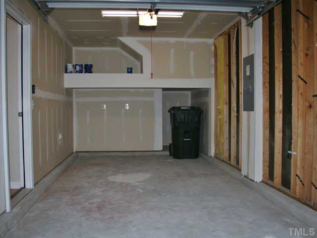 6009 Ladish Lane Raleigh, NC 27610 - Photo 17 of 21 Inside view of the garage, notice the extra storage above and below in the rear, also comes with auto garage door opener.