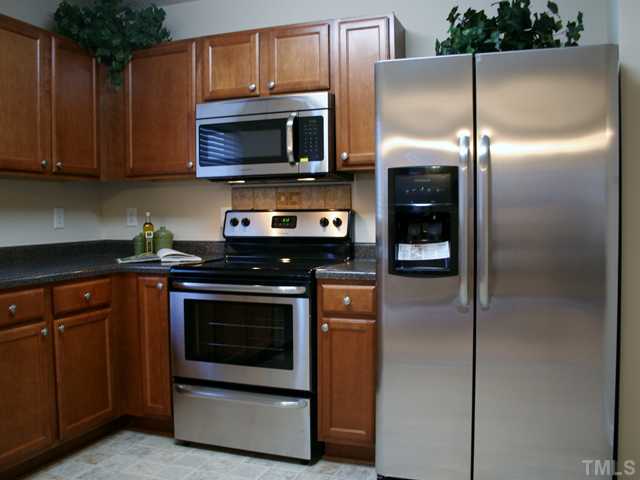 6009 Ladish Lane Raleigh, NC 27610 - Photo 7 of 21 Closer view of the brand new stainless appliances, new smooth top stove, new microwave, new dishwasher, and FREE new side by side Fridge.