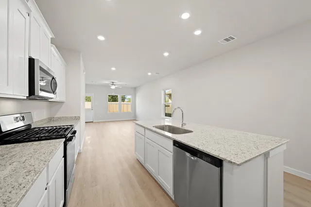 a kitchen with a sink and cabinets