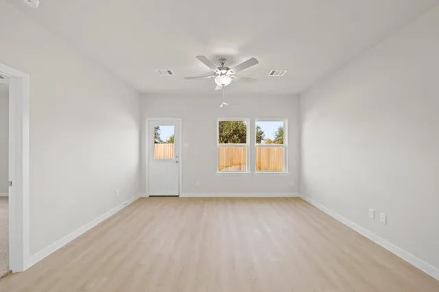 wooden floor in an empty room with a window