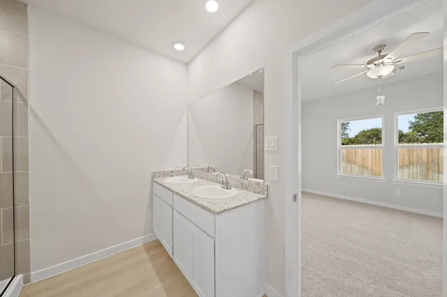 a bathroom with a sink vanity and a mirror