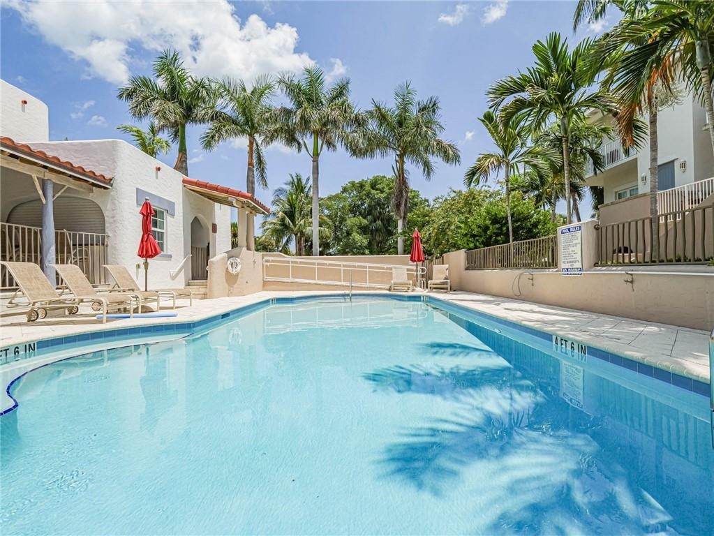 1564 Island Cove Road, Unit 1564 Fort Pierce, FL 34949 - Photo 22 of 26 a swimming pool with outdoor seating and yard