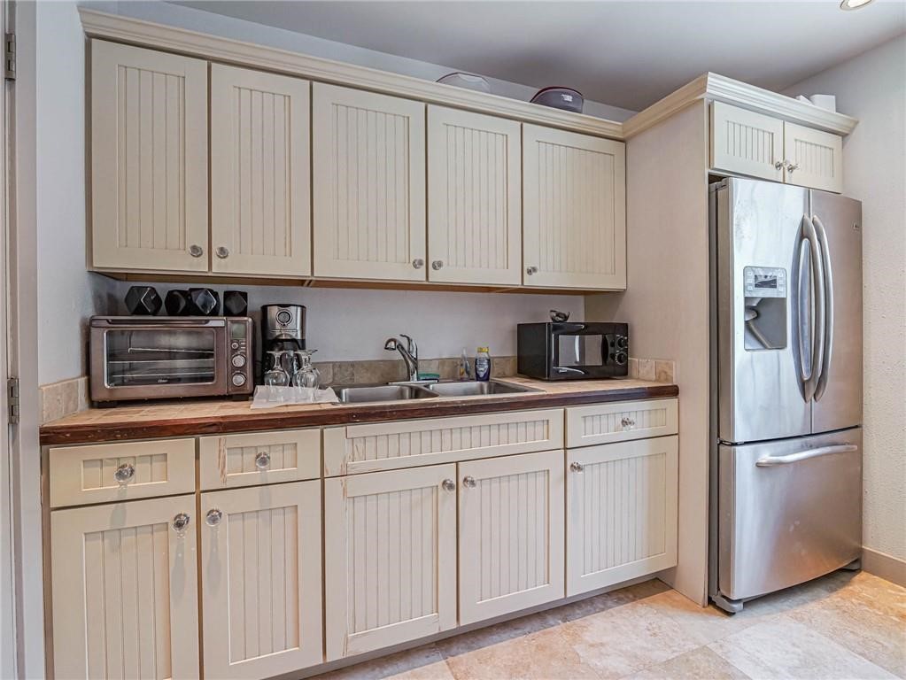 1564 Island Cove Road, Unit 1564 Fort Pierce, FL 34949 - Photo 26 of 26 a kitchen with white cabinets and refrigerator