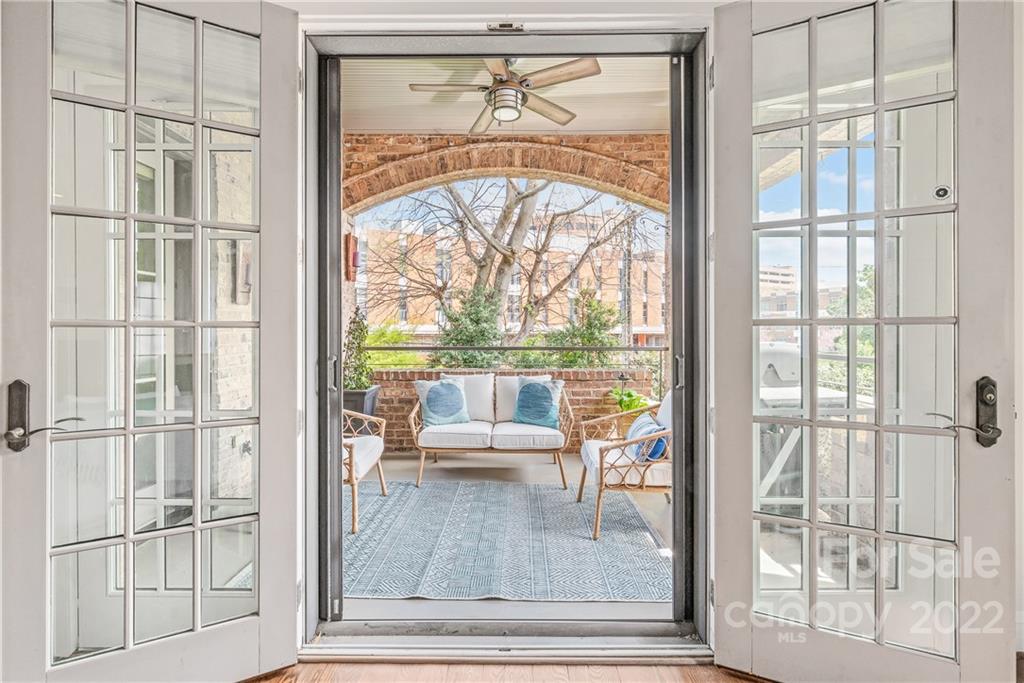 255 Queens Road, Unit 255 Charlotte, NC 28204 - Photo 11 of 32 a view of an entryway with wooden floor and a floor to ceiling window