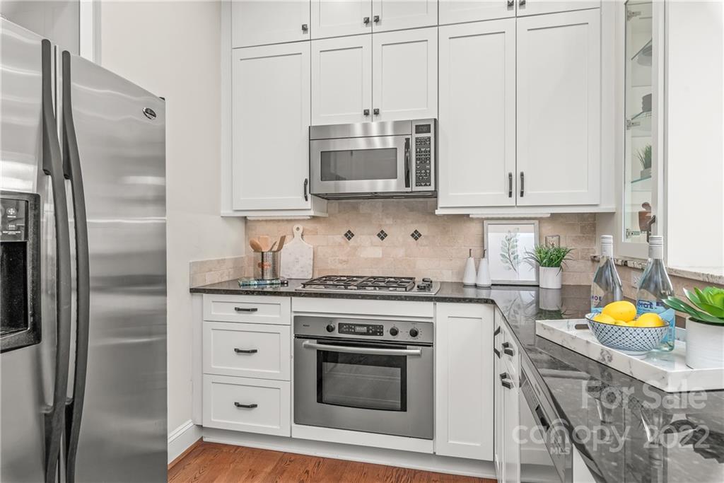 255 Queens Road, Unit 255 Charlotte, NC 28204 - Photo 16 of 32 a kitchen with stainless steel appliances granite countertop a stove a refrigerator and a stove