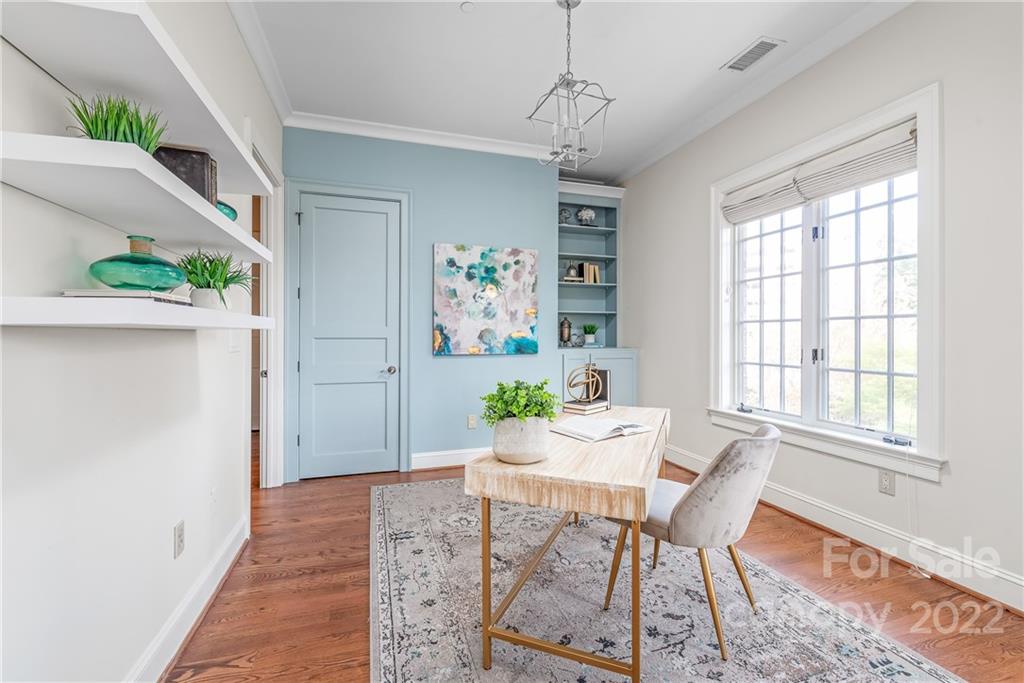 255 Queens Road, Unit 255 Charlotte, NC 28204 - Photo 21 of 32 a view of a dining room with furniture window and wooden floor