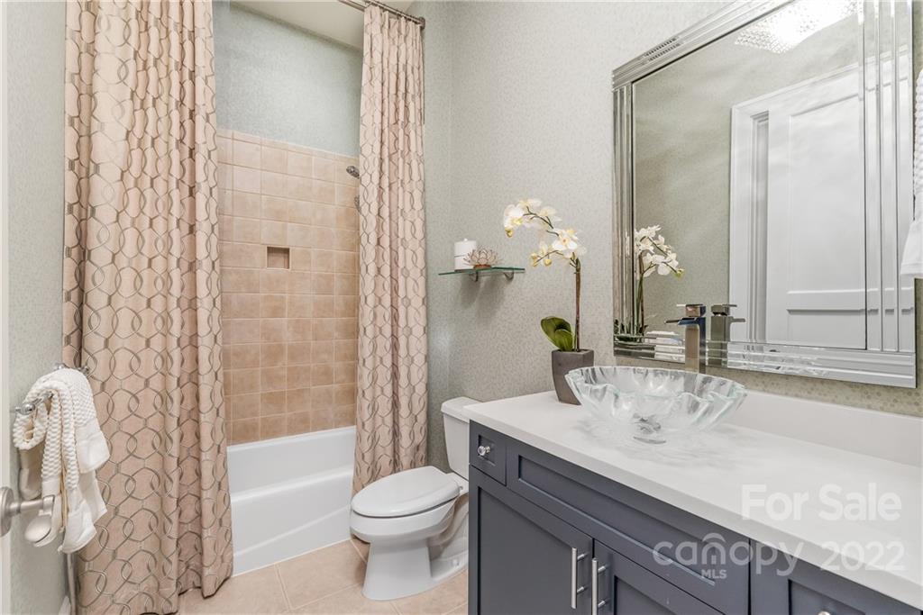 255 Queens Road, Unit 255 Charlotte, NC 28204 - Photo 23 of 32 a bathroom with a granite countertop sink a toilet and shower