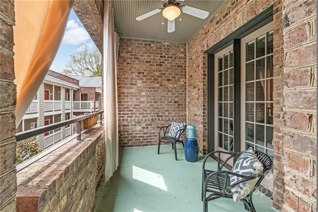 255 Queens Road, Unit 255 Charlotte, NC 28204 - Photo 24 of 32 a view of balcony with two chairs and a rug