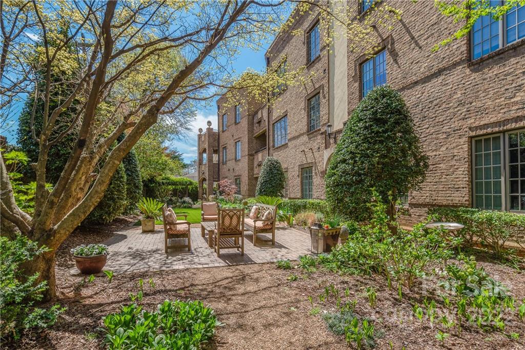 255 Queens Road, Unit 255 Charlotte, NC 28204 - Photo 27 of 32 a view of a patio with table and chairs and potted plants