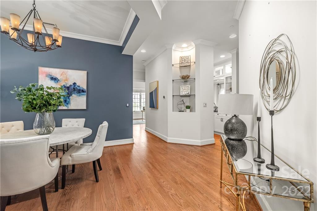 255 Queens Road, Unit 255 Charlotte, NC 28204 - Photo 8 of 32 a view of a dining room with furniture and wooden floor