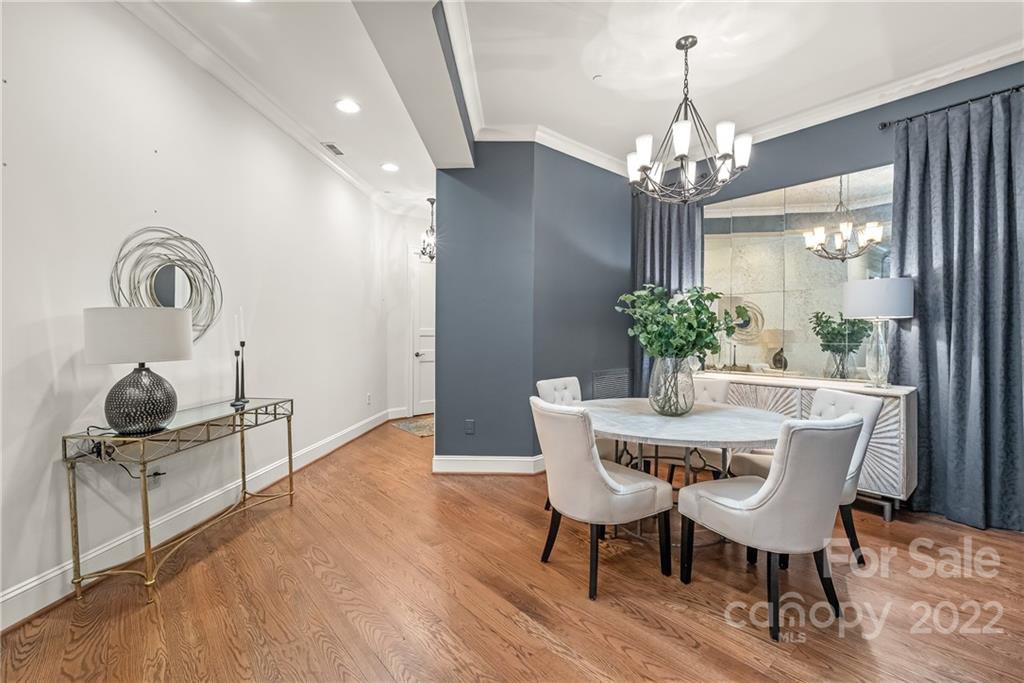 255 Queens Road, Unit 255 Charlotte, NC 28204 - Photo 9 of 32 a view of a dining room with furniture and chandelier