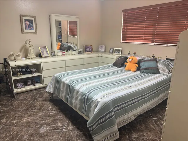 a bedroom with a bed and a dresser