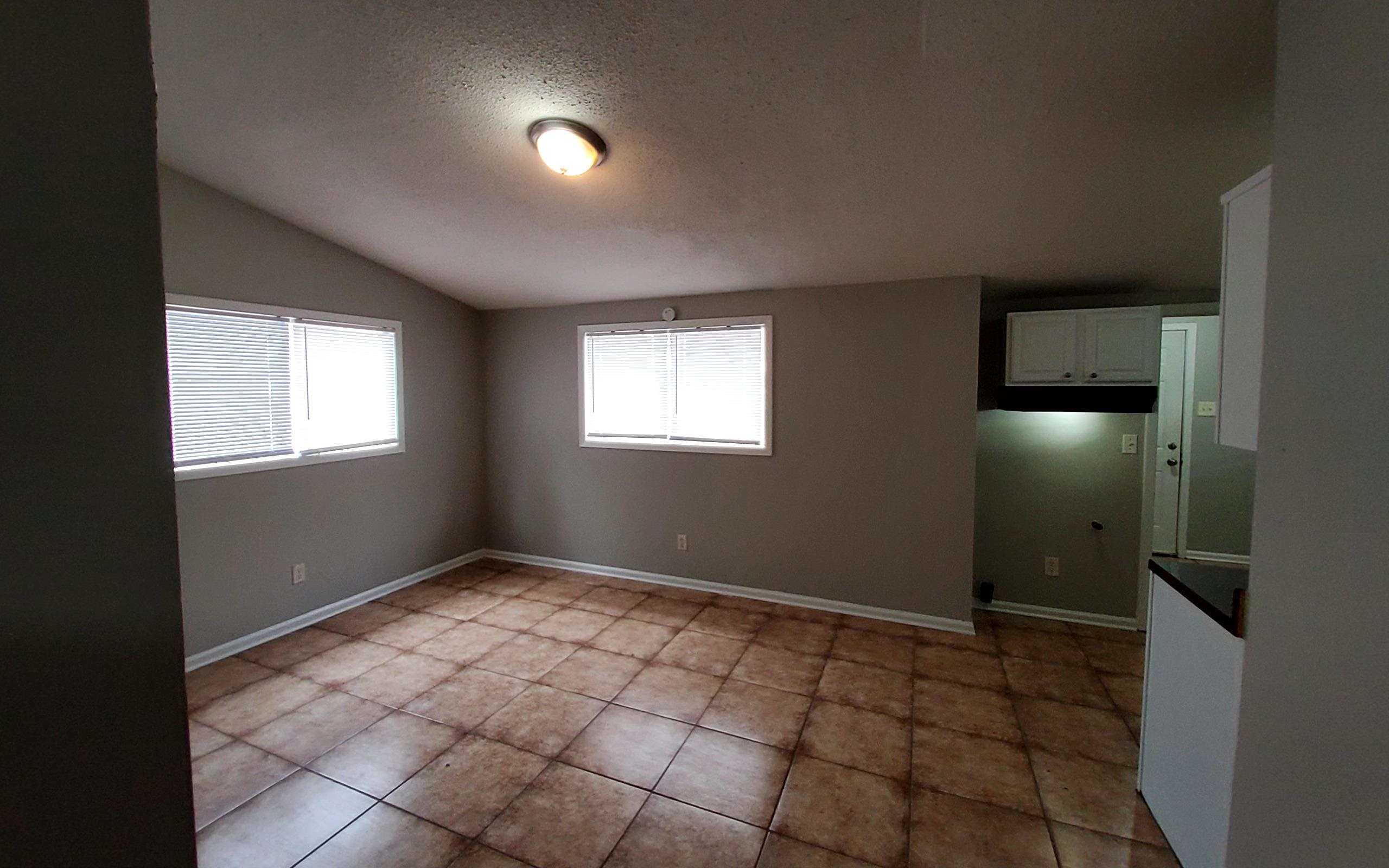 4227 Hobson Road Memphis, TN 38128 - Photo 9 of 12 a view of an empty room with window and chandelier fan