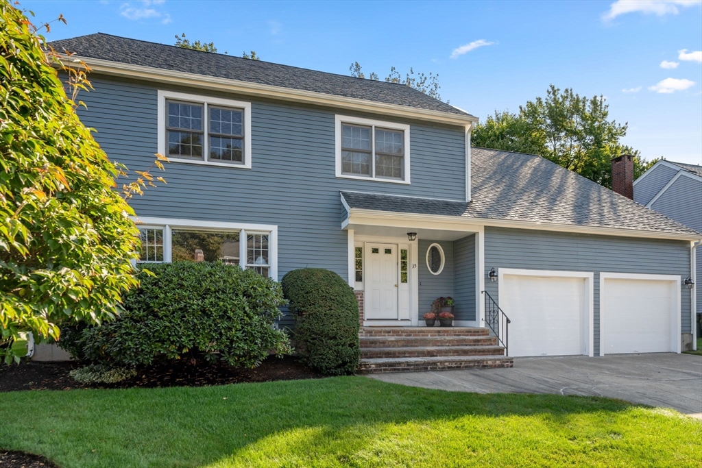 a view of a house with a yard and plants