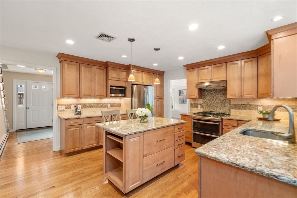 35 Lynn Road Needham, MA 02494 - Photo 11 of 38 a kitchen with a stove a sink a refrigerator and cabinets