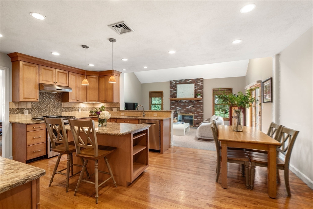 35 Lynn Road Needham, MA 02494 - Photo 12 of 38 a kitchen with a table chairs microwave and cabinets