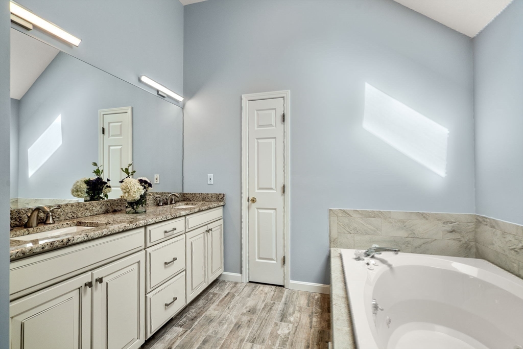 35 Lynn Road Needham, MA 02494 - Photo 19 of 38 a spacious bathroom with a granite countertop sink and a mirror