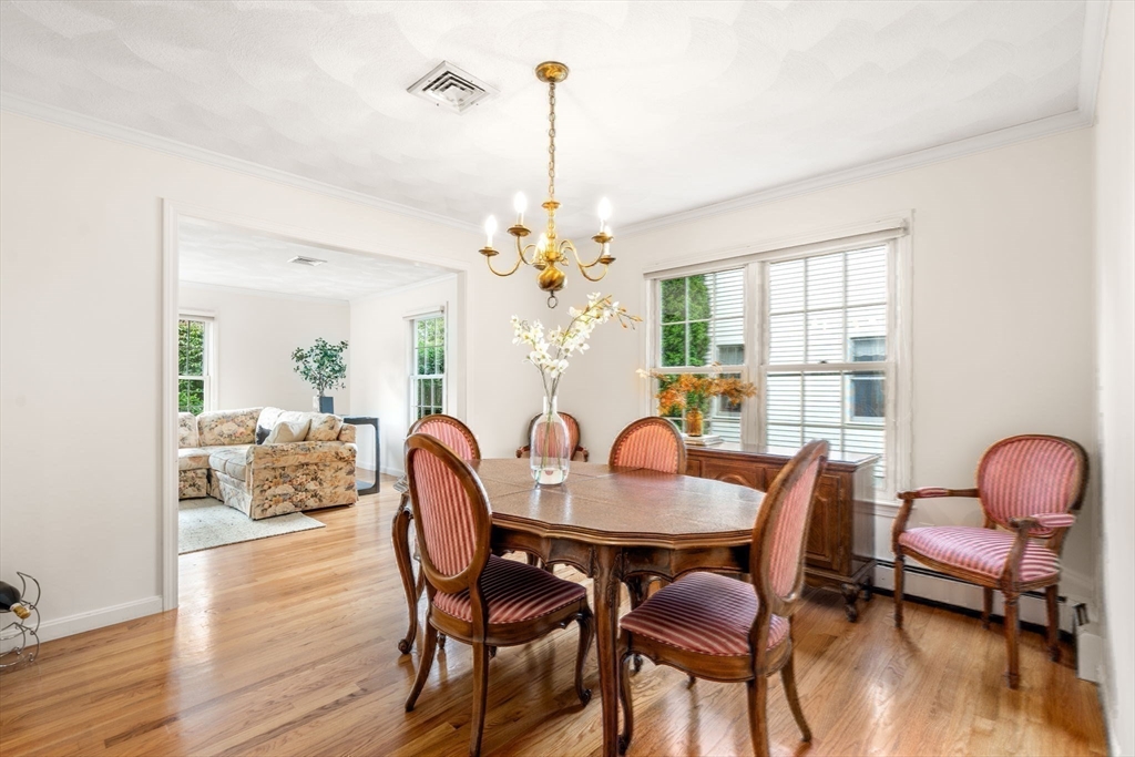 35 Lynn Road Needham, MA 02494 - Photo 9 of 38 a dining room with furniture a chandelier and wooden floor