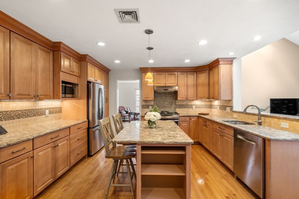 35 Lynn Road Needham, MA 02494 - Photo 10 of 38 a kitchen with counter top space sink stove and cabinets