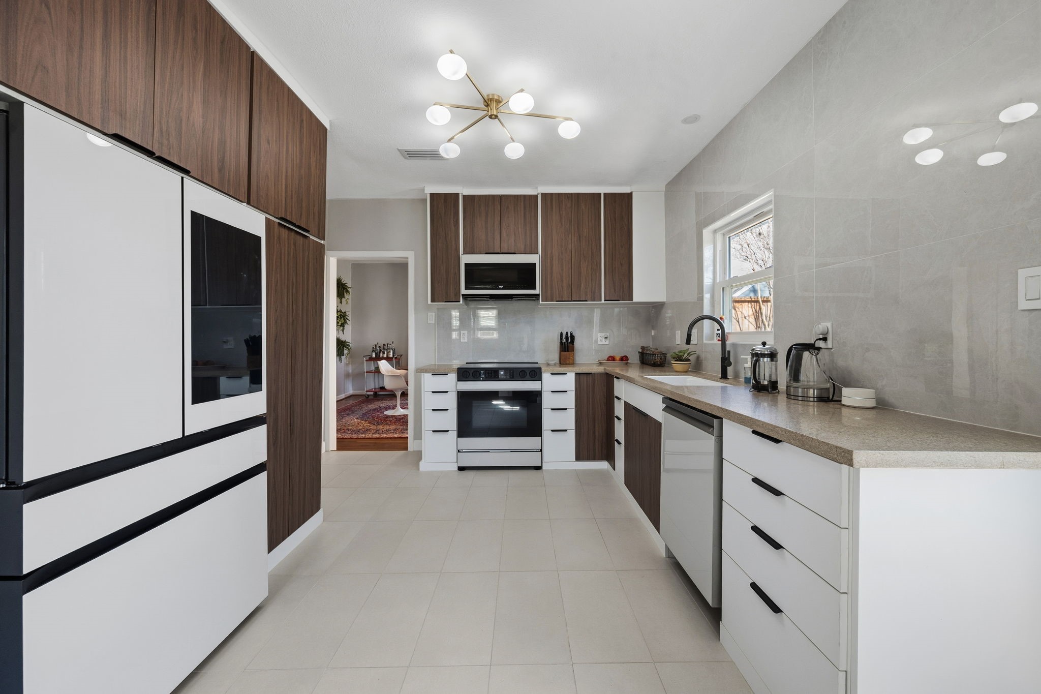 1831 Palm Street Houston, TX 77004 - Photo 10 of 27 It has a stylish overhead light fixture and a large window that provides natural light, creating a bright and welcoming atmosphere.