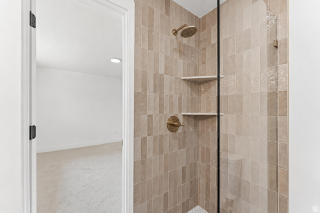 1898 West 600 South Provo, UT 84601 - Photo 14 of 32 Contemporary shower enclosure featuring textured rectangular tile, glass panel, and built-in shelving