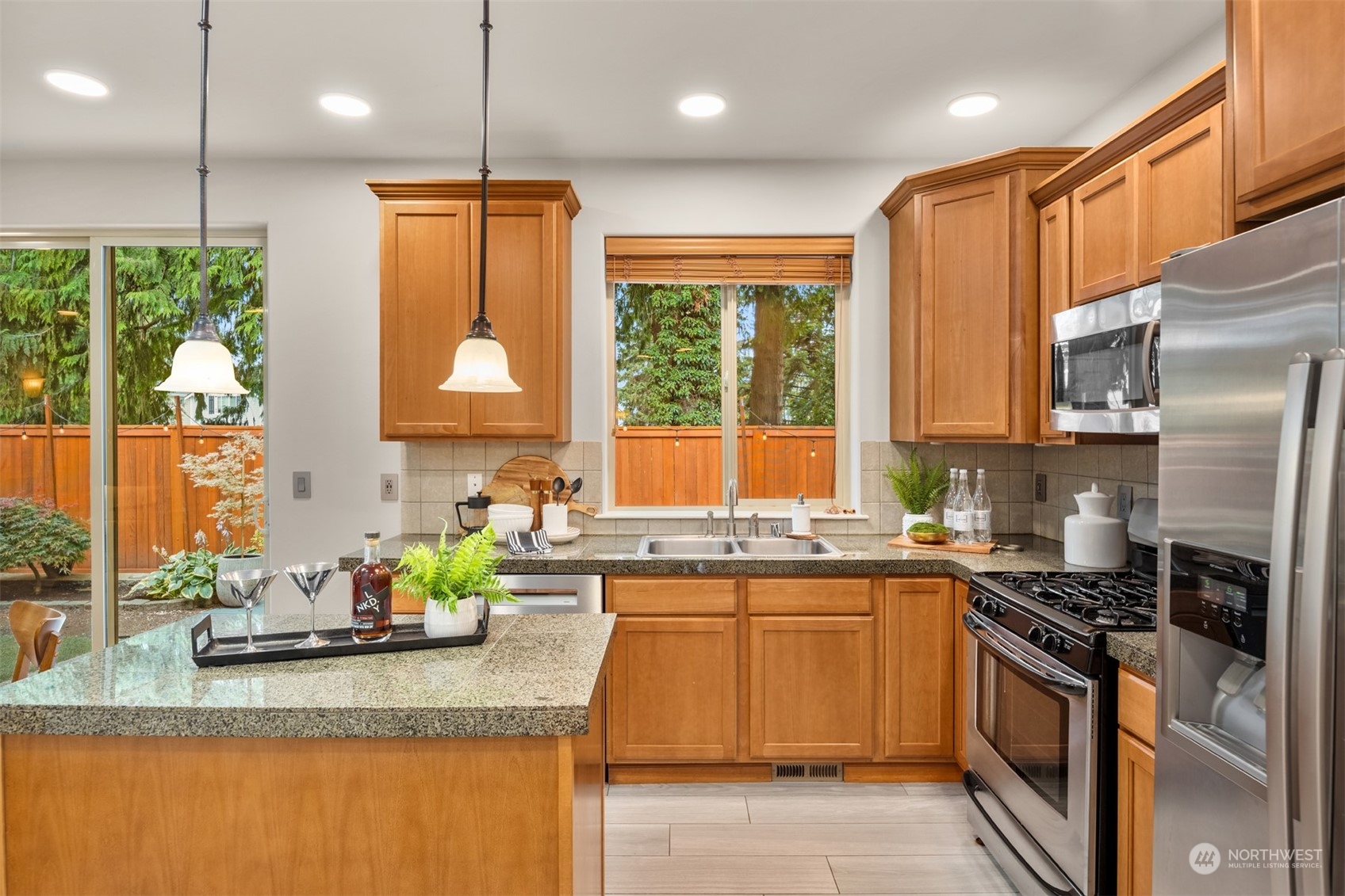 23116 87th Avenue West Edmonds, WA 98026 - Photo 11 of 27 a kitchen with stainless steel appliances granite countertop a sink a stove a refrigerator cabinets and a large window