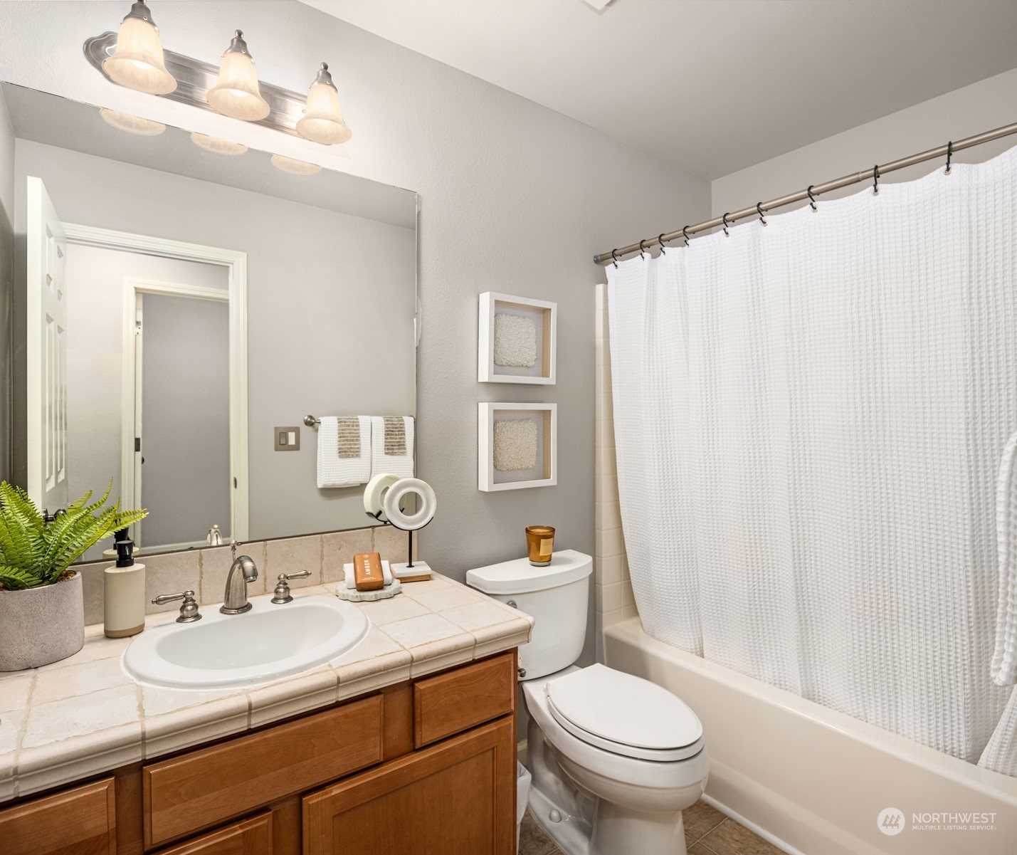 23116 87th Avenue West Edmonds, WA 98026 - Photo 20 of 27 a bathroom with a granite countertop sink toilet and a mirror