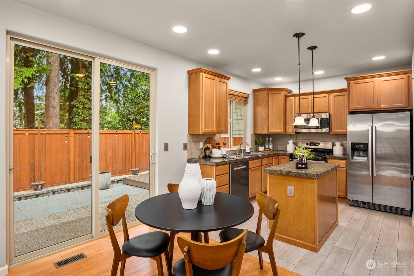23116 87th Avenue West Edmonds, WA 98026 - Photo 8 of 27 a kitchen with granite countertop kitchen island stainless steel appliances a table and chairs