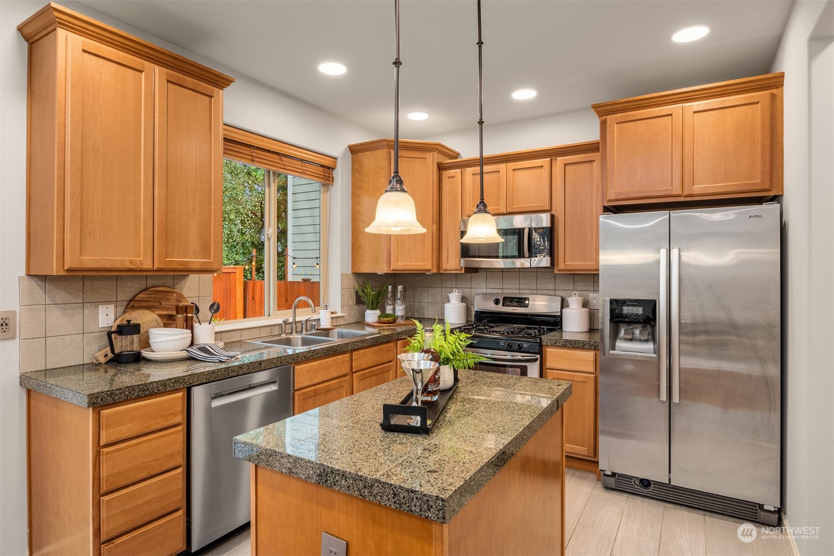 23116 87th Avenue West Edmonds, WA 98026 - Photo 10 of 27 a kitchen with granite countertop stainless steel appliances a refrigerator a sink a stove cabinets and living room view