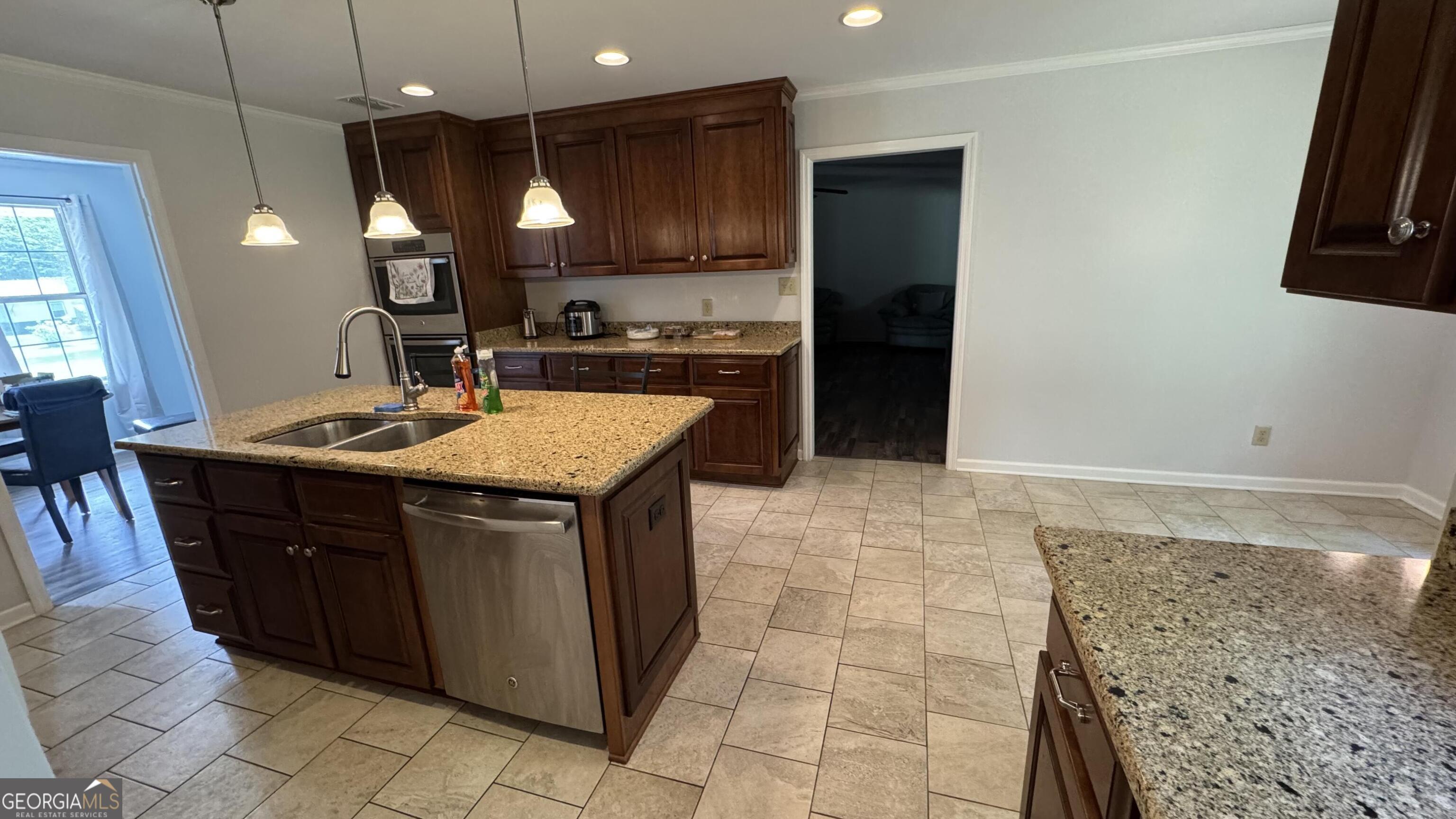 355 Summer Hill Road Thomasville, GA 31757 - Photo 11 of 50 a kitchen with stainless steel appliances granite countertop a sink stove and refrigerator