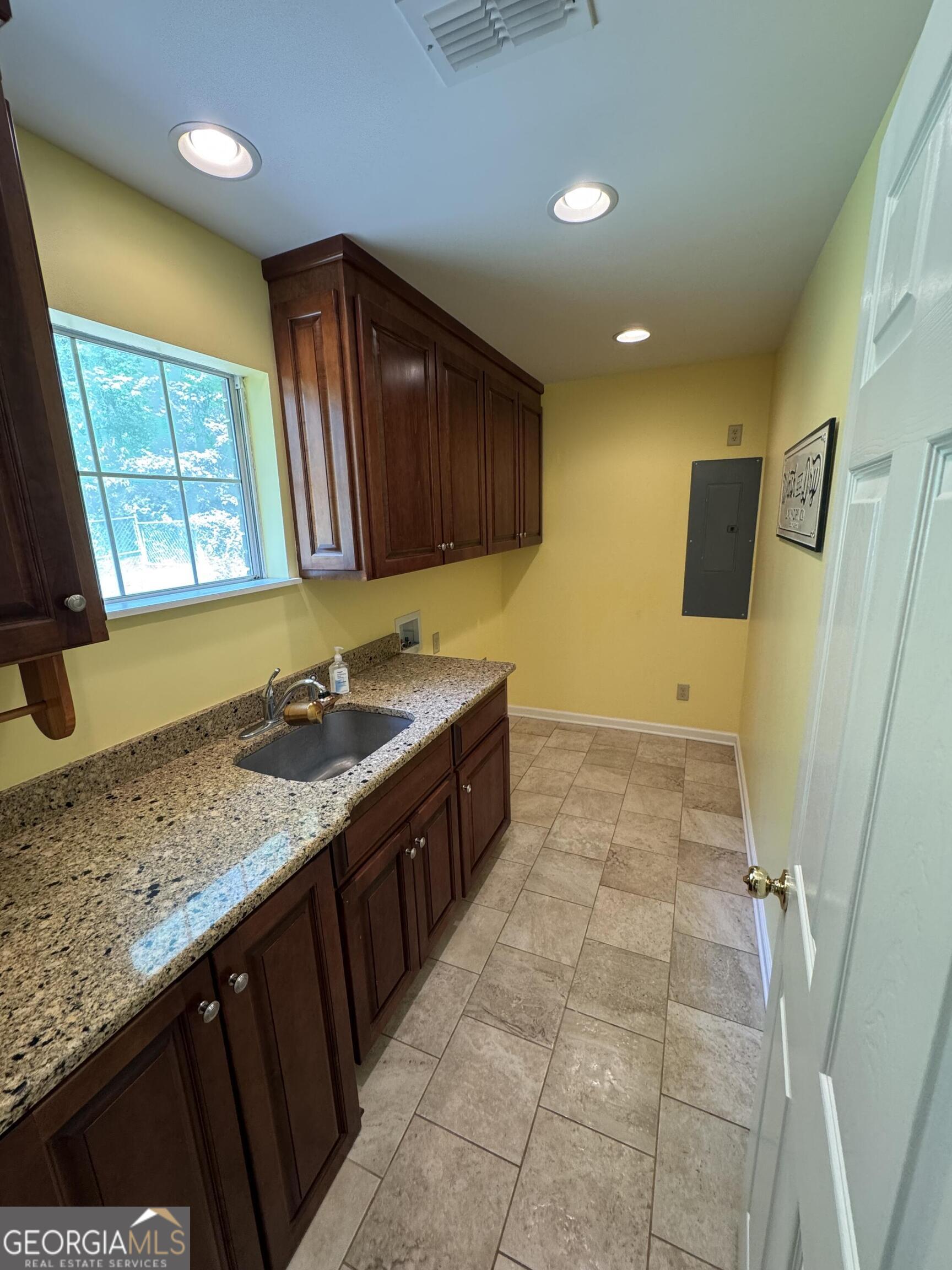355 Summer Hill Road Thomasville, GA 31757 - Photo 13 of 50 a kitchen with a sink a stove and cabinets