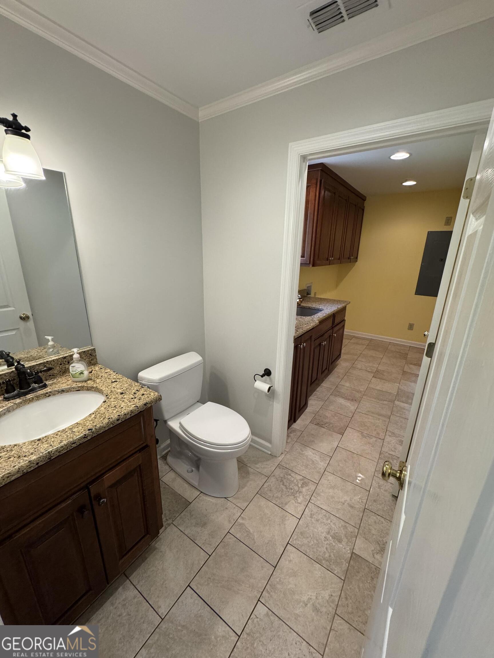 355 Summer Hill Road Thomasville, GA 31757 - Photo 15 of 50 a spacious bathroom with a granite countertop sink and a mirror