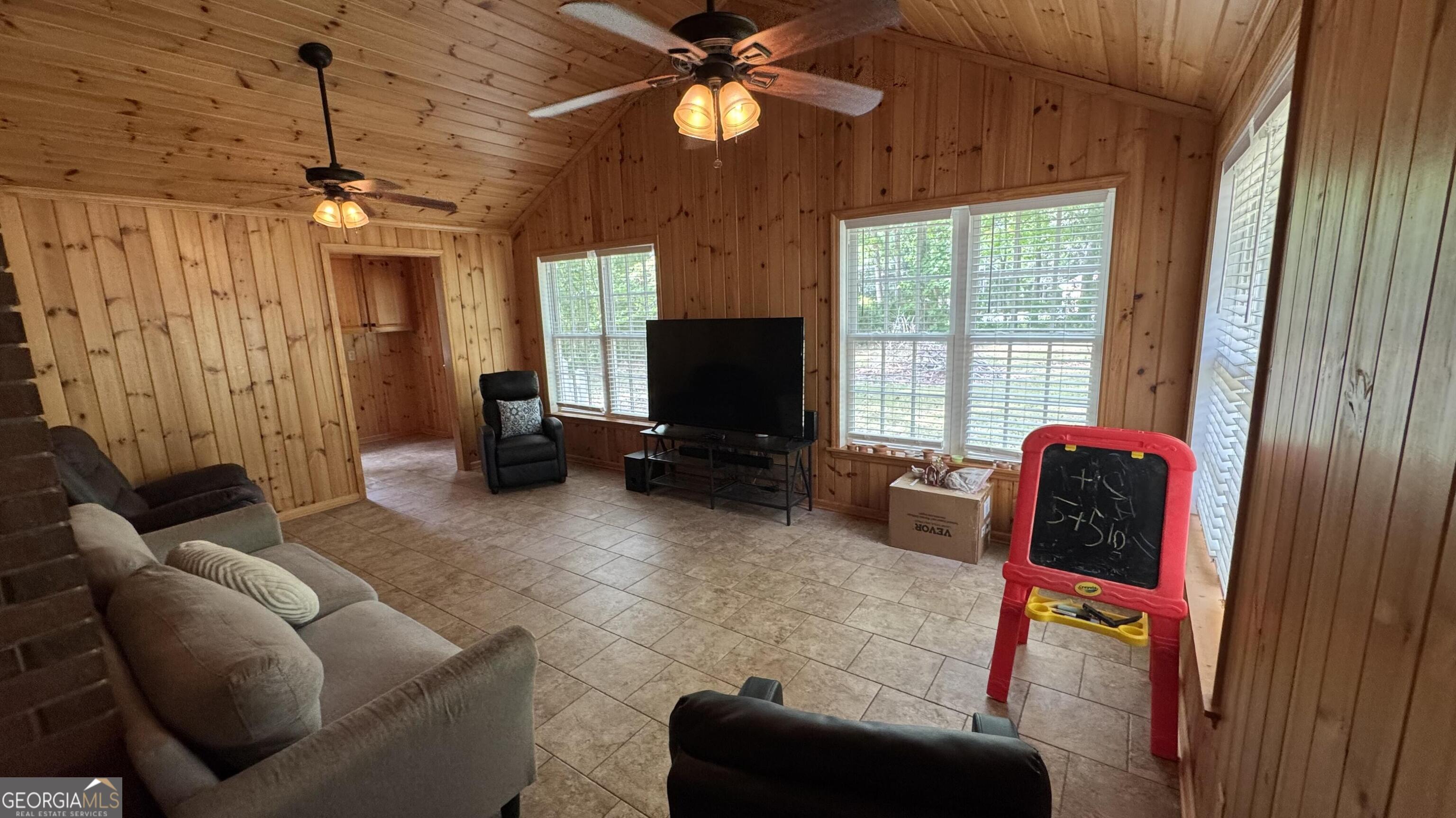 355 Summer Hill Road Thomasville, GA 31757 - Photo 18 of 50 a living room with furniture a chandelier and a flat screen tv