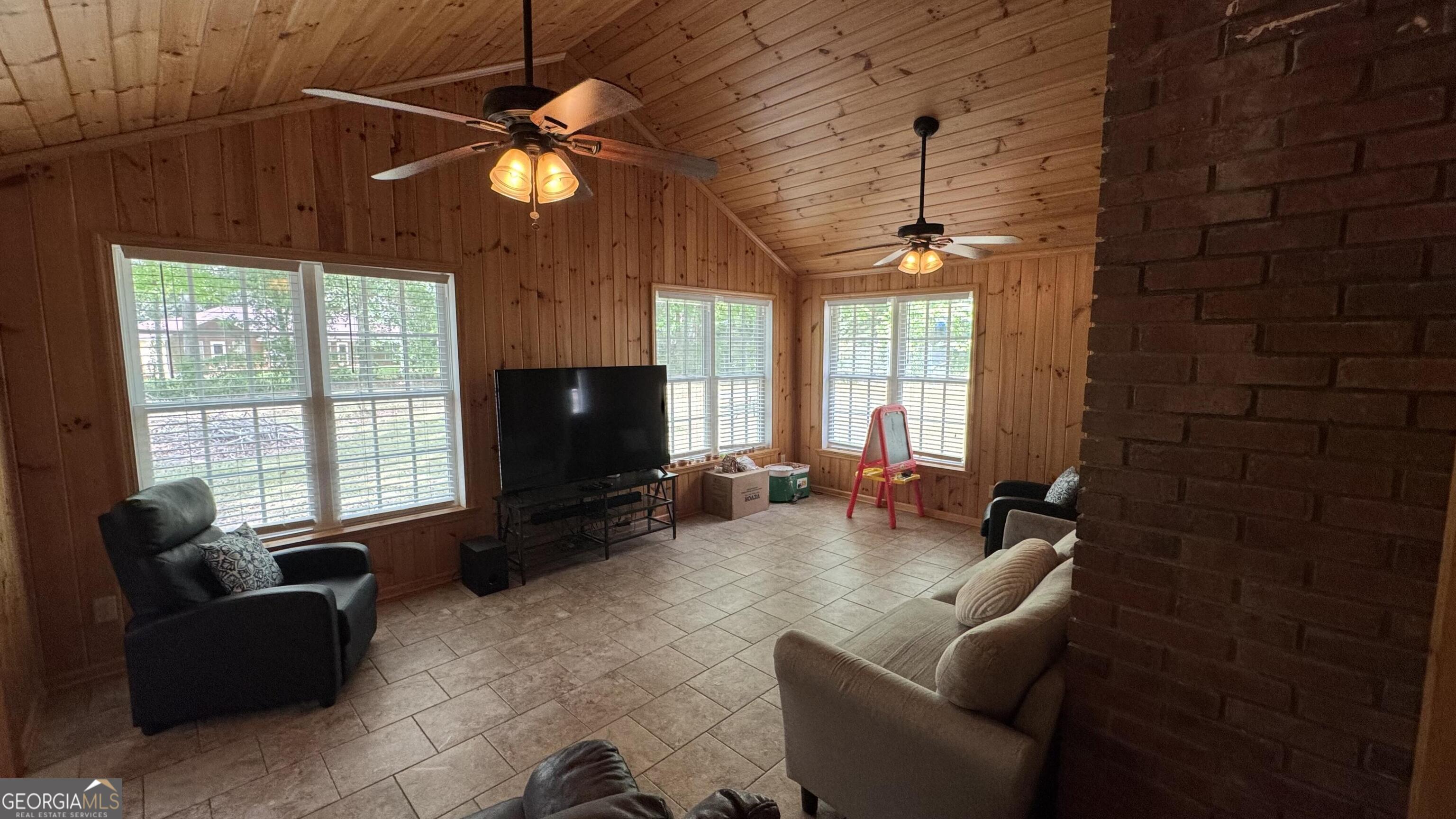 355 Summer Hill Road Thomasville, GA 31757 - Photo 21 of 50 a living room with furniture a flat screen tv and a chandelier