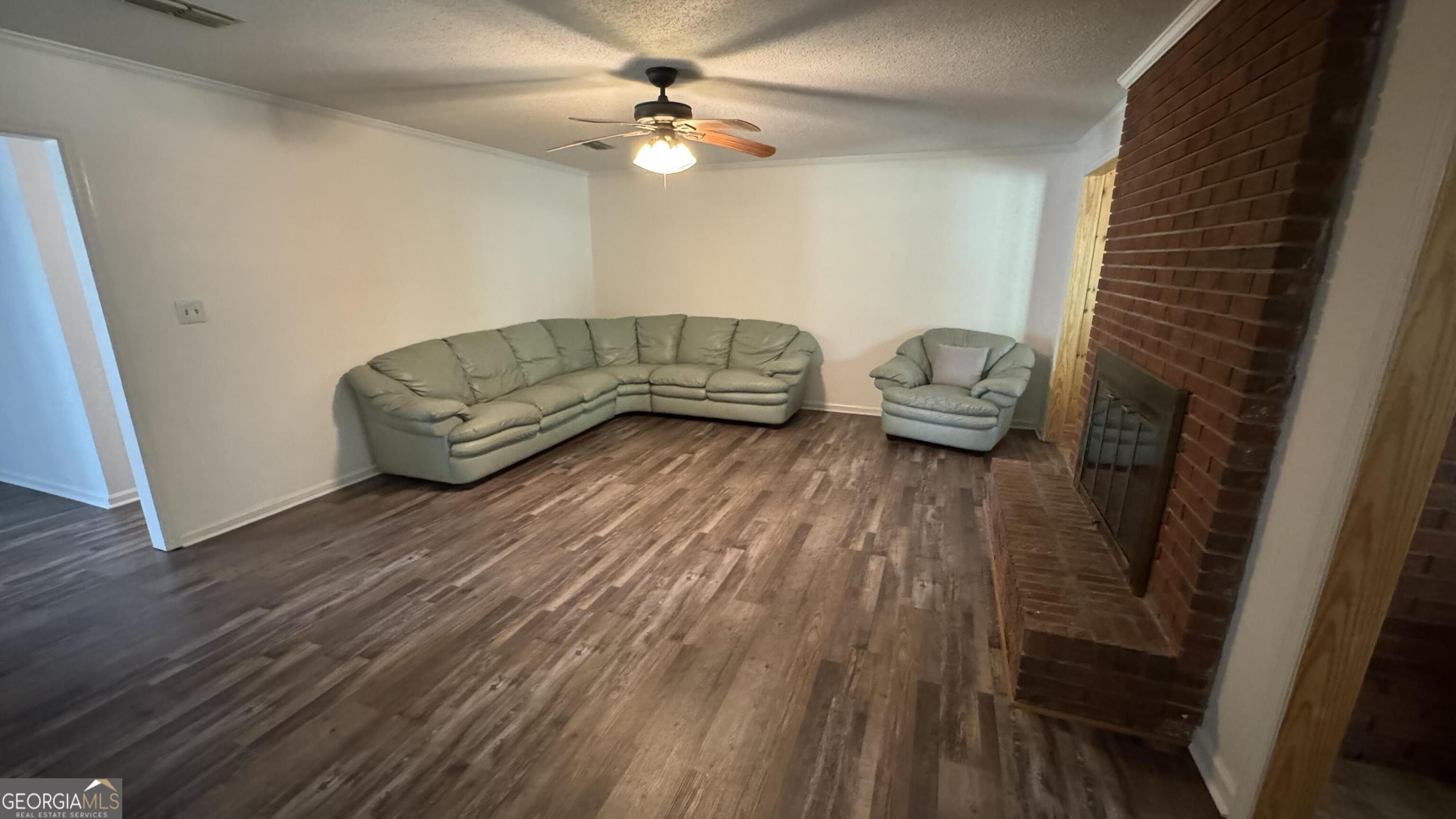 355 Summer Hill Road Thomasville, GA 31757 - Photo 25 of 50 a living room with furniture and a wooden floor