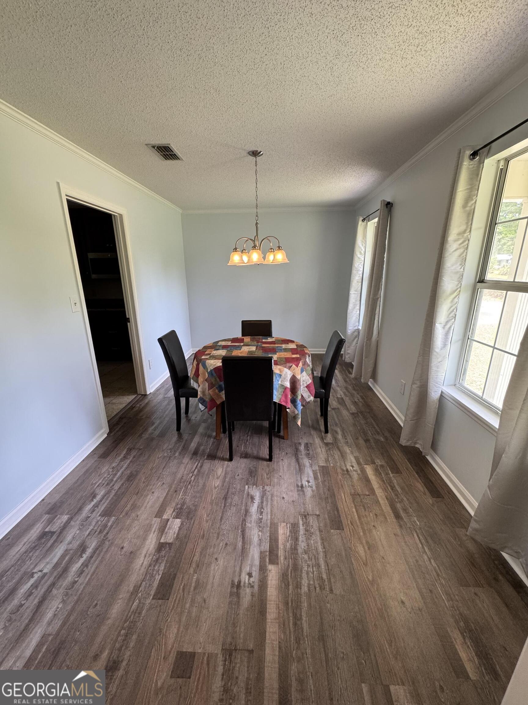 355 Summer Hill Road Thomasville, GA 31757 - Photo 30 of 50 a dining room with furniture a chandelier and wooden floor