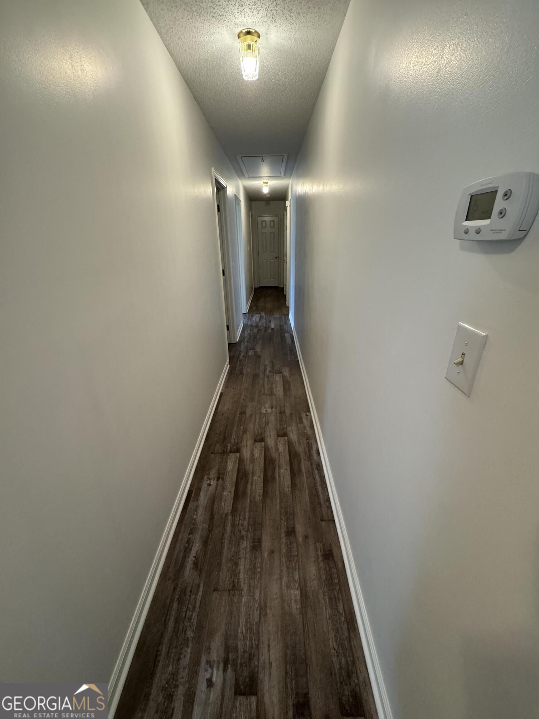 355 Summer Hill Road Thomasville, GA 31757 - Photo 32 of 50 a view of a hallway with wooden floor