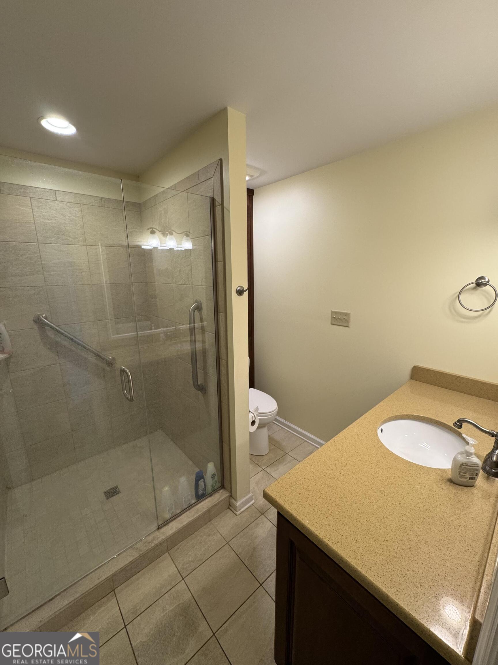 355 Summer Hill Road Thomasville, GA 31757 - Photo 35 of 50 a bathroom with a granite countertop sink a toilet and shower