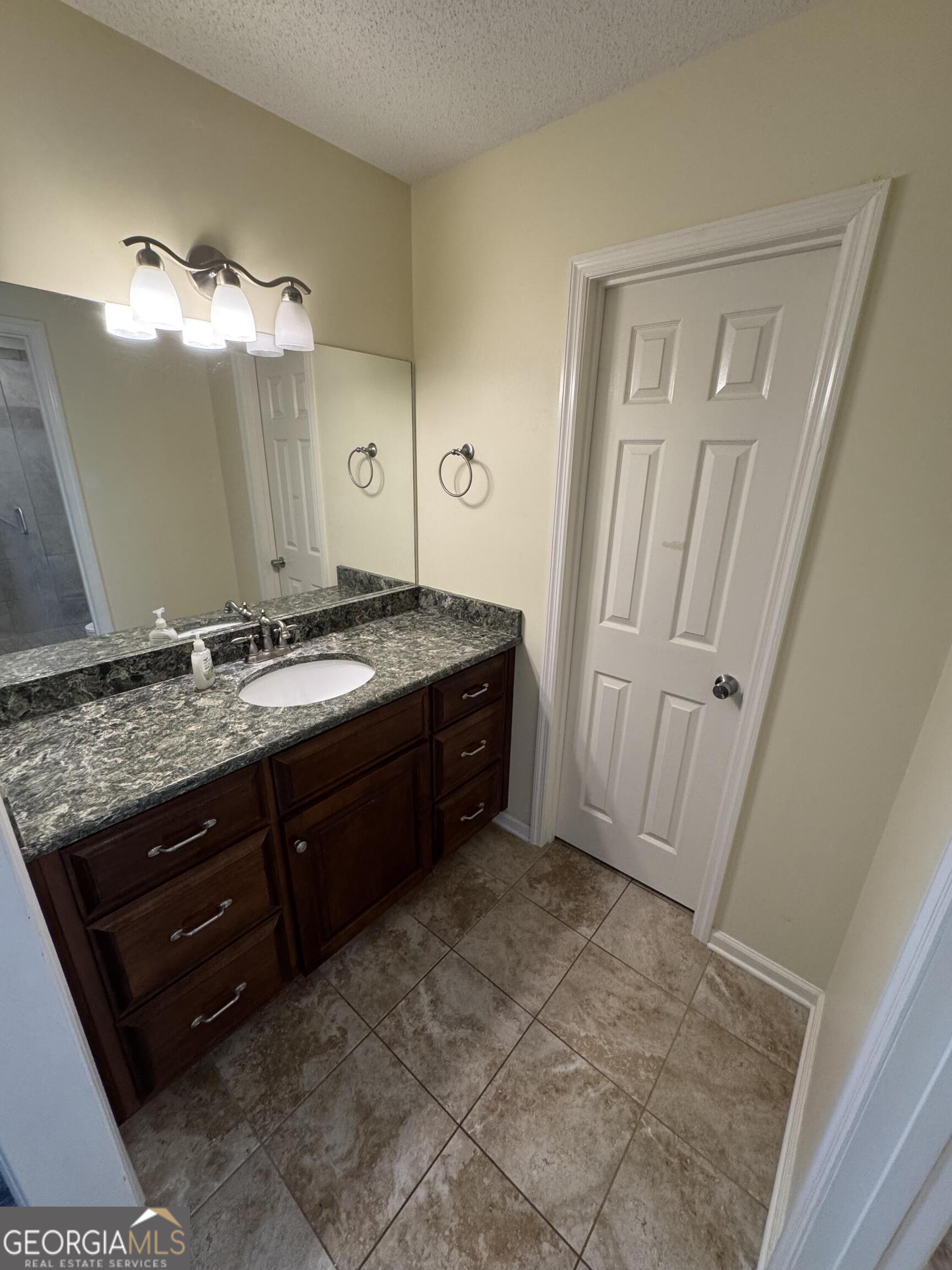 355 Summer Hill Road Thomasville, GA 31757 - Photo 44 of 50 a spacious bathroom with a granite countertop sink and a mirror