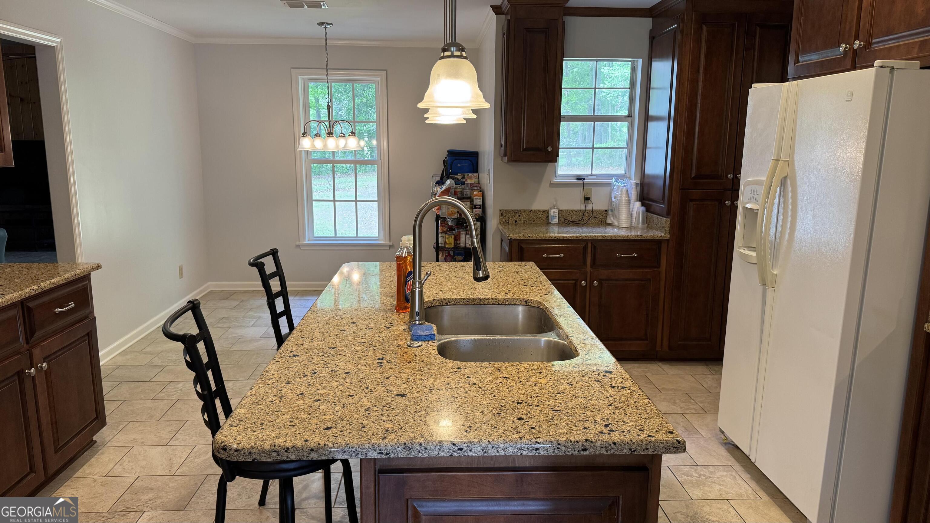 355 Summer Hill Road Thomasville, GA 31757 - Photo 8 of 50 a kitchen with kitchen island granite countertop a sink a stove and refrigerator