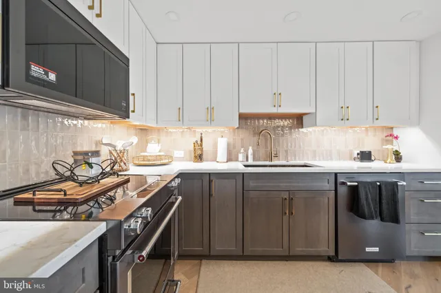 a kitchen with a sink appliances and cabinets