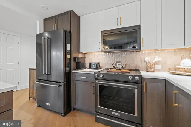 a kitchen with stainless steel appliances a stove a microwave and a refrigerator
