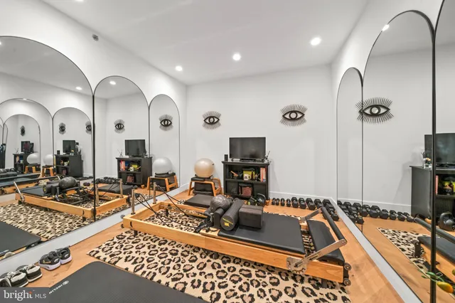 a room with gym equipment and view of living room